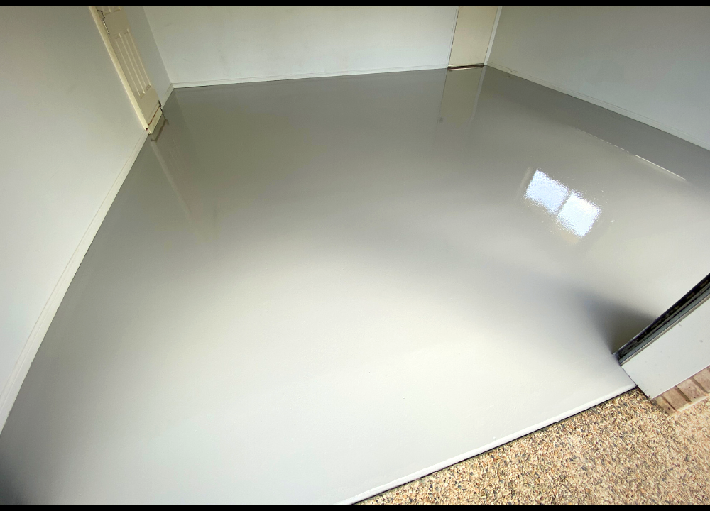 Completed light grey epoxy floor in a residential garage